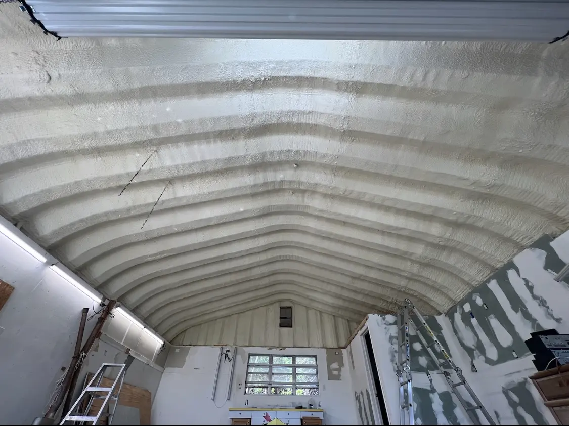 Spray polyurethane foam applied to the underside of a metal roof deck in Niceville